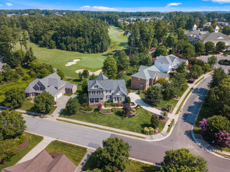 Aerial drone view of an upscale residential neighbourhood along a golf course